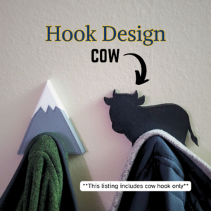 A Cow coat hook designed to hang sweatshirts, jackets and towels created by Ziggy Zig Designs.